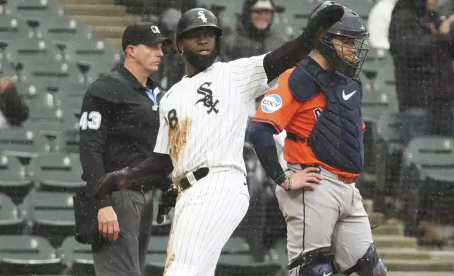 Chicago White Sox's Luis Robert Jr., center, celebrates after scoring on a one-run single by Edgar Quero during the sixth inning of a baseball game against the Houston Astros in Chicago, Sunday, May 4, 2025. (AP Photo/Nam Y. Huh)