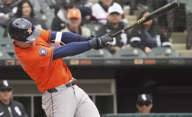 Houston Astros' Zach Dezenzo hits a single during the second inning of a baseball game against the Chicago White Sox in Chicago, Sunday, May 4, 2025. (AP Photo/Nam Y. Huh)