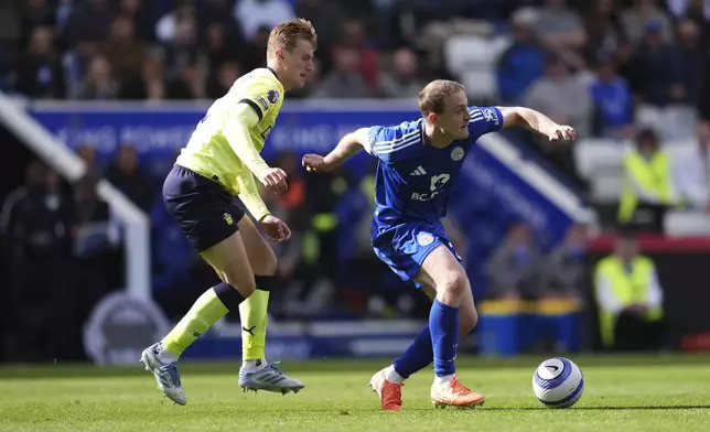 Southampton's Flynn Downes, left, and Leicester City's Oliver Skipp in action during the English Premier League soccer match between Leicester City and Southampton at the King Power Stadium, Leicester, England, Saturday May 3, 2025. (Adam Davy/PA via AP)