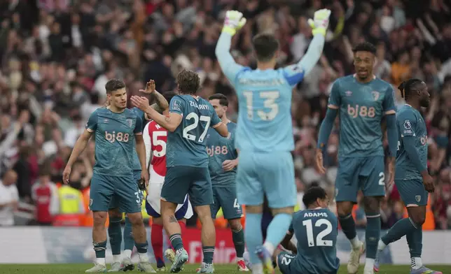 Bournemouth players celebrate at the end of the English Premier League soccer match between Arsenal and Bournemouth at Emirates stadium in London, Saturday, May 3, 2025. (AP Photo/Kin Cheung)
