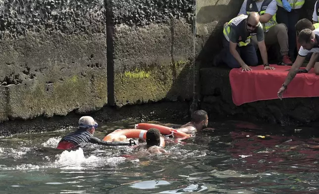 Survivors of a capsized boat are rescued in the port of El Hierro in the Canary Islands, Spain, on Wednesday, May 28, 2025. (Europa Press via AP)