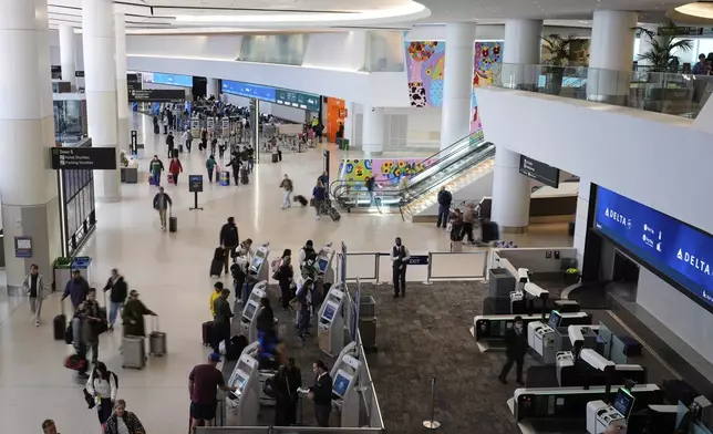 Travelers make their way through Terminal 1 at San Francisco International Airport ahead of the Memorial Day holiday weekend in San Francisco, Thursday, May 22, 2025. (AP Photo/Godofredo A. Vásquez)
