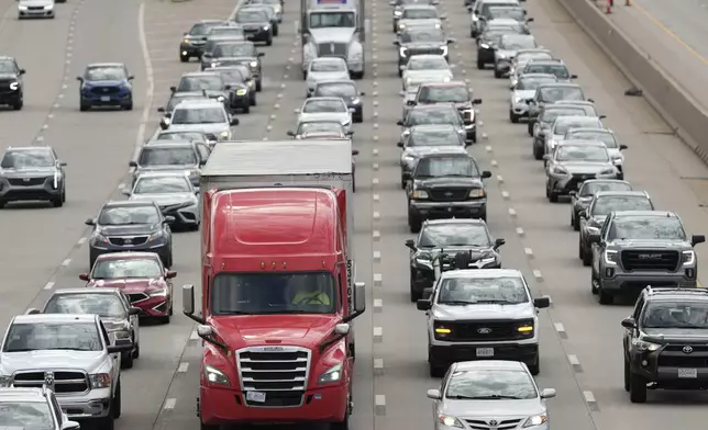 Vehicles travel on Interstate 435 ahead of Memorial Day weekend, Thursday, May 22, 2025, in Overland Park, Kan. (AP Photo/Charlie Riedel)
