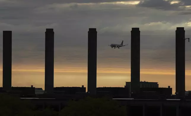 An airplane descends into landing at O'Hare International Airport in Chicago, Friday, May 23, 2025. (AP Photo/Nam Y. Huh)