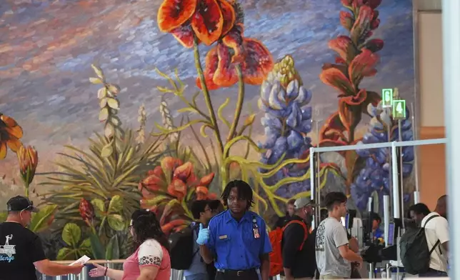Travellers are directed to lines through security at Love Field airport Friday, May 23, 2025, in Dallas. (AP Photo/LM Otero)