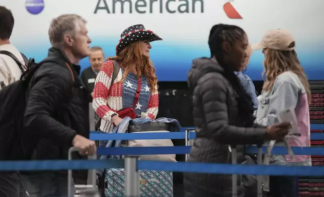 Travelers wait to go through security check point the weekend before Memorial Day at O'Hare International Airport in Chicago, Friday, May 23, 2025. (AP Photo/Nam Y. Huh)