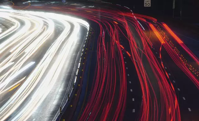 In this long exposure photograph traffic moves along Interstate 76 ahead of the Memorial Day holiday weekend, in Philadelphia, Thursday, May 22, 2025. (AP Photo/Matt Rourke)