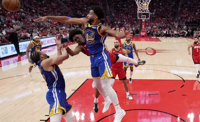 Houston Rockets forward Amen Thompson has his shot blocked by Golden State Warriors forward Braxton Key (12) during the second half of Game 5 of an NBA basketball first-round playoff series, Wednesday, April 30, 2024, in Houston. (AP Photo/David J. Phillip)