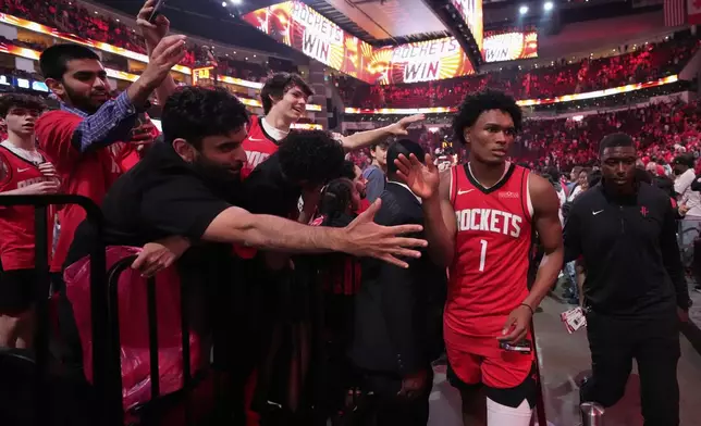 Houston Rockets forward Amen Thompson high fives fans after Game 5 of an NBA basketball first-round playoff series against the Golden State Warriors, Wednesday, April 30, 2025, in Houston. (AP Photo/David J. Phillip)