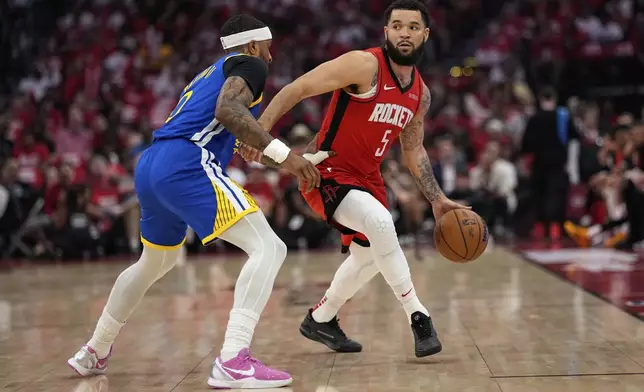 Houston Rockets guard Fred VanVleet (5) moves the ball up court as Golden State Warriors guard Gary Payton II defends during the first half of Game 5 of an NBA basketball first-round playoff series, Wednesday, April 30, 2025, in Houston. (AP Photo/David J. Phillip)