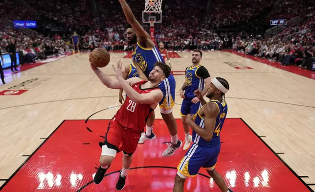 Houston Rockets center Alperen Sengun (28) shoots as Golden State Warriors forward Trayce Jackson-Davis (32) defends during the second half of Game 5 of an NBA basketball first-round playoff series, Wednesday, April 30, 2024, in Houston. (AP Photo/David J. Phillip)