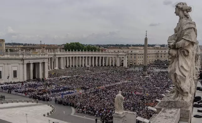 FILE - A crowd gathers in St. Peter's Square at the Vatican, where newly elected Pope Leo XIV will deliver a blessing from the central balcony of St. Peter's Basilica on Sunday, May 11, 2025. (AP Photo/Domenico Stinellis, File)