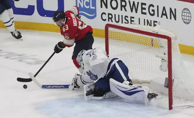 Toronto Maple Leafs goaltender Joseph Woll (60) defends against a shot by Florida Panthers center Brad Marchand (63) during the second period in Game 3 of a second-round NHL hockey playoff series, Friday, May 9, 2025, in Sunrise, Fla. (AP Photo/Marta Lavandier)