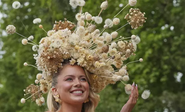 Model and dancer Tasha Ghouri poses as she wears a head piece for The King's Trust garden designed by Joe Perkins at the RHS Chelsea Flower Show in London, Monday, May 19, 2025. (AP Photo/Kirsty Wigglesworth)
