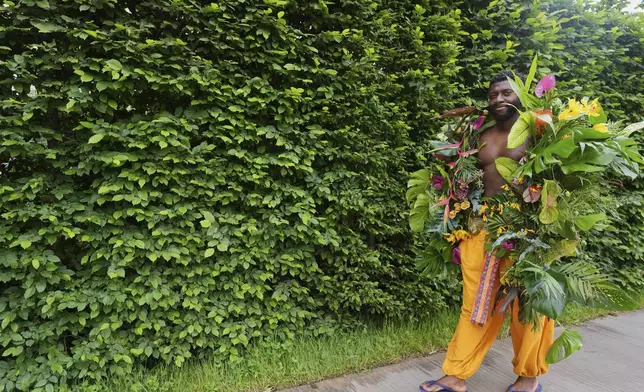 Dane Foxx from Acacia Creative Studio models a floral outfit at the RHS Chelsea Flower Show in London, Monday, May 19, 2025. (AP Photo/Kirsty Wigglesworth)