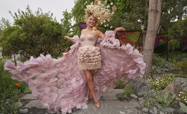 Model and dancer Tasha Ghouri poses as she wears a head piece for The King's Trust garden designed by Joe Perkins at the RHS Chelsea Flower Show in London, Monday, May 19, 2025. (AP Photo/Kirsty Wigglesworth)