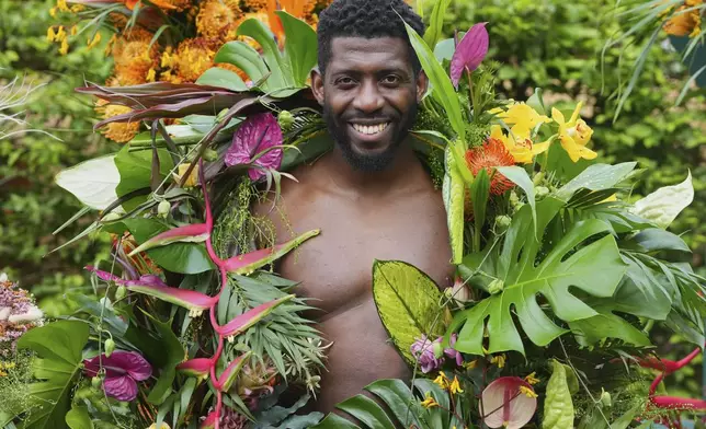 Dane Foxx from Acacia Creative Studio models a floral outfit at the RHS Chelsea Flower Show in London, Monday, May 19, 2025. (AP Photo/Kirsty Wigglesworth)