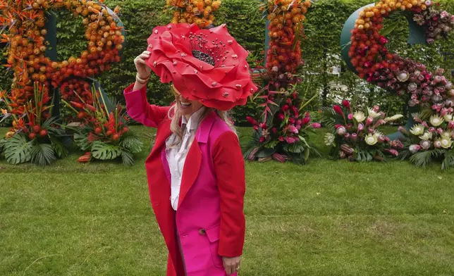 A show visitor wears a floral themed hat at the RHS Chelsea Flower Show in London, Monday, May 19, 2025. (AP Photo/Kirsty Wigglesworth)
