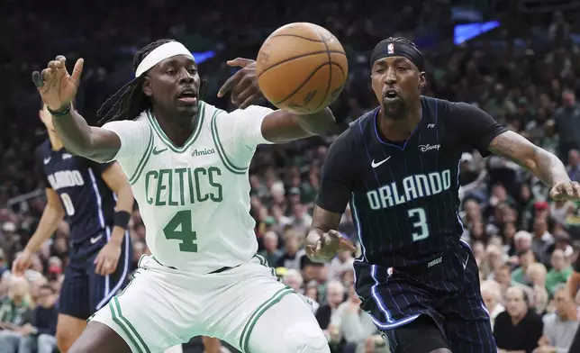 Boston Celtics' Jrue Holiday (4) looses control of the ball against Orlando Magic's Kentavious Caldwell-Pope (3) during the first half in game 1 of a first-round NBA playoff basketball series Sunday, April 20, 2025, in Boston. (AP Photo/Michael Dwyer)