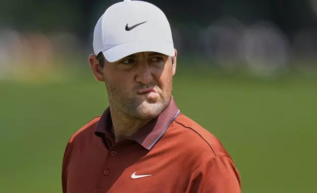 Scottie Scheffler reacts after the 16th hole during the first round of the PGA Championship golf tournament at the Quail Hollow Club, Thursday, May 15, 2025, in Charlotte, N.C. (AP Photo/David J. Phillip)