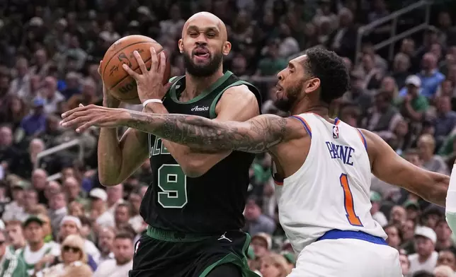 Boston Celtics guard Derrick White (9) drives to the basket against New York Knicks guard Cameron Payne (1) during the first half of Game 5 of an NBA basketball second-round playoff series, Wednesday, May 14, 2025, in Boston. (AP Photo/Charles Krupa)