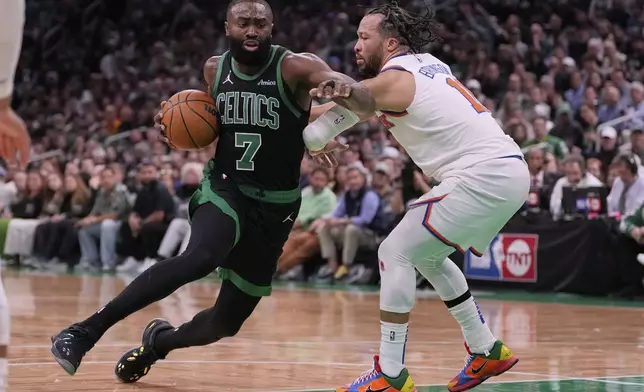 Boston Celtics guard Jaylen Brown (7) drives to the basket against New York Knicks guard Jalen Brunson, right, during the first half of Game 5 of an NBA basketball second-round playoff series, Wednesday, May 14, 2025, in Boston. (AP Photo/Charles Krupa)