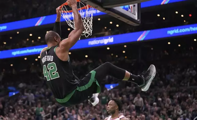 Boston Celtics center Al Horford (42) dunks against the New York Knicks during the first half of Game 5 of an NBA basketball second-round playoff series, Wednesday, May 14, 2025, in Boston. (AP Photo/Charles Krupa)