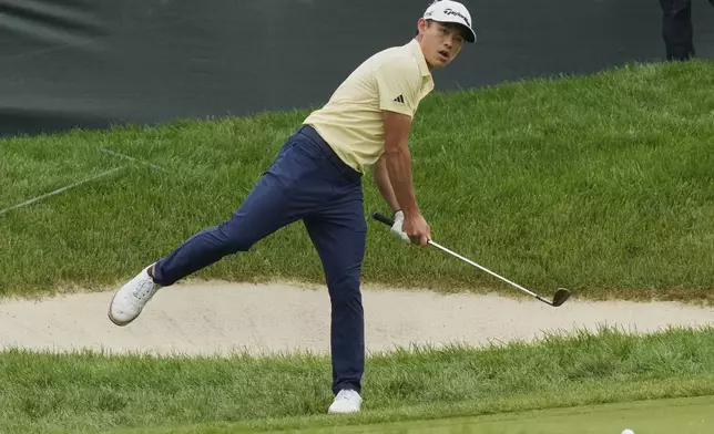 Collin Morikawa reacts after hitting onto the 13th green during the second round of the Memorial golf tournament Friday, May 30, 2025, in Dublin, Ohio. (AP Photo/Sue Ogrocki)