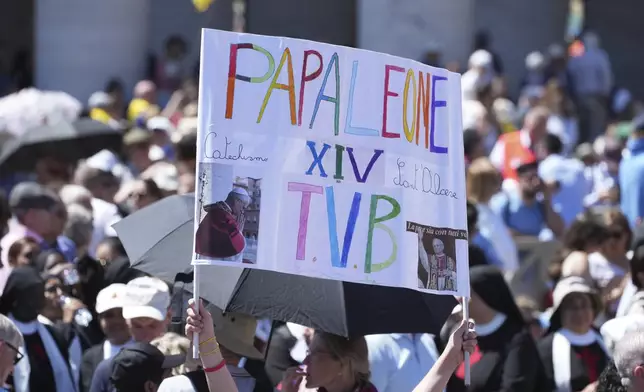 Faithful hold a banner reading "Pope Leo XIV I love you", ahead of Pope Leo XIV blesses faithful and pilgrims gathered in St. Peter's Square for the Regina Caeli noon prayer, Sunday, May 25, 2025. (AP Photo/Andrew Medichini)