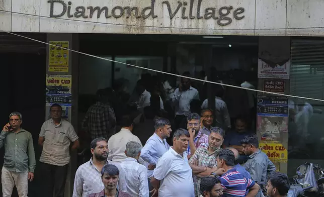 Diamond traders wait for clients at a market in Surat, India, on April 14, 2025. (AP Photo/Ajit Solanki)