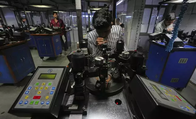 An employee works at a diamond cutting and processing workshop in Surat, India, on April 14, 2025. (AP Photo/Ajit Solanki)
