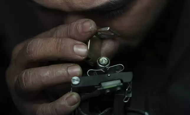 A worker inspects a diamond at Shree Ramkrishna Exports in Surat, India, on April 14, 2025. (AP Photo/Ajit Solanki)