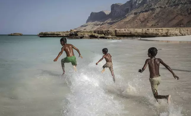Children play in the waves on the Yemeni island of Socotra on Sept. 22, 2024. (AP Photo/Annika Hammerschlag)