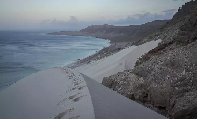 Sand dunes plunge into the sea on the Yemeni island of Socotra on Sept. 21, 2024. (AP Photo/Annika Hammerschlag)