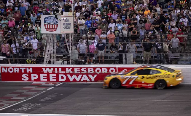 Carson Hocevar gets the checkered flag in the NASCAR All-Star Open auto race Sunday, May 18, 2025, in North Wilkesboro, N.C. (AP Photo/Scott Kinser)
