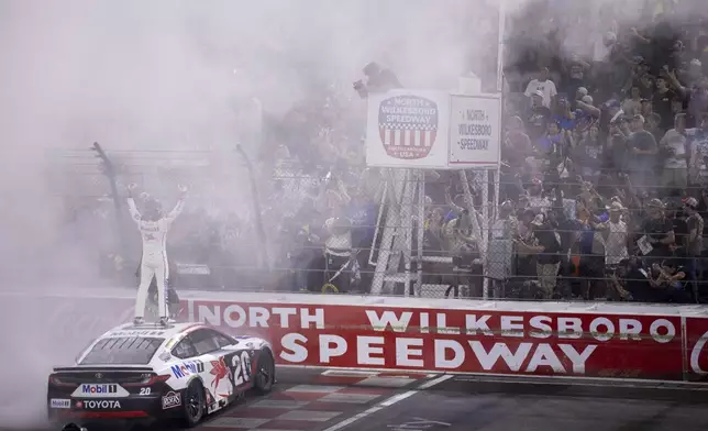 Christopher Bell celebrates winning the NASCAR All-Star auto race Sunday, May 18, 2025, in North Wilkesboro, N.C. (AP Photo/Scott Kinser)