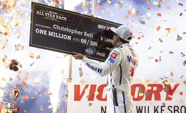 Christopher Bell celebrates after winning the NASCAR All-Star auto race Sunday, May 18, 2025, in North Wilkesboro, N.C. (AP Photo/Scott Kinser)