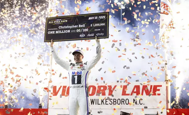 Christopher Bell celebrates after winning the NASCAR All-Star auto race Sunday, May 18, 2025, in North Wilkesboro, N.C. (AP Photo/Scott Kinser)