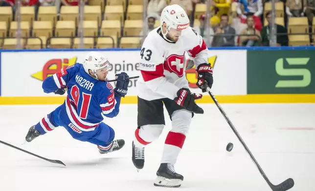 U.S. Frank Nazar, left, fights for the puck with Switzerland Andrea Glauser during the IIHF Ice Hockey World Championship group B match between the U.S. and Switzerland in Herning, Denmark, Monday, May 12, 2025. (Bo Amstrup/Ritzau Scanpix via AP)