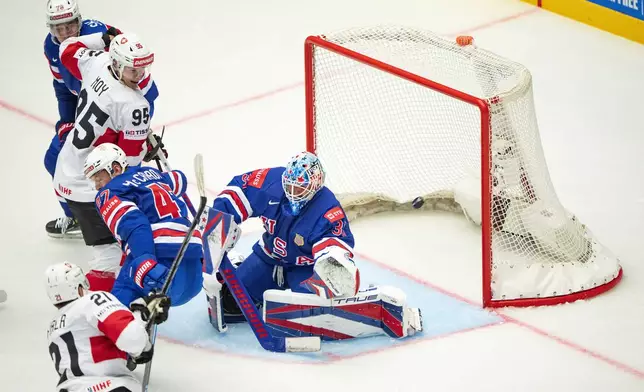 Switzerland Kevin Fiala, left, and Tyler Moy challenge for the puck against U.S. Michael McCarron, center left, and goalkeeper Joey Daccord and Brady Skjei during the IIHF Ice Hockey World Championship group B match between the U.S. and Switzerland in Herning, Denmark, Monday, May 12, 2025. (Bo Amstrup/Ritzau Scanpix via AP)