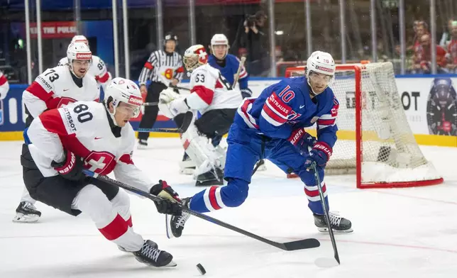U.S. Matty Beniers, right, challenges Switzerland Nicolas Baechler during the IIHF Ice Hockey World Championship group B match between the U.S. and Switzerland in Herning, Denmark, Monday, May 12, 2025. (Bo Amstrup/Ritzau Scanpix via AP)