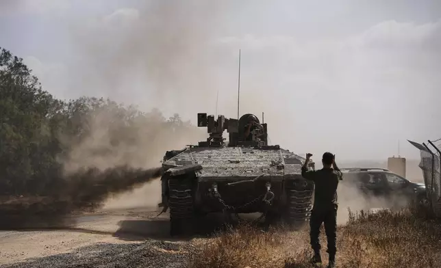 Israeli forces move along the border with the Gaza Strip, in southern Israel, Monday, May 19, 2025. (AP Photo/Ohad Zwigenberg)