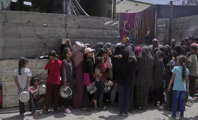 Palestinians line up for donated food at a community kitchen in Jabalia, in the northern Gaza Strip, on Monday, May 19, 2025. (AP Photo/Jehad Alshrafi)