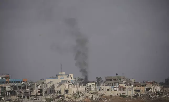 Smoke rises following an Israeli army bombardment in Khan Younis, Gaza, as seen from southern Israel, Monday, May 19, 2025. (AP Photo/Ohad Zwigenberg)