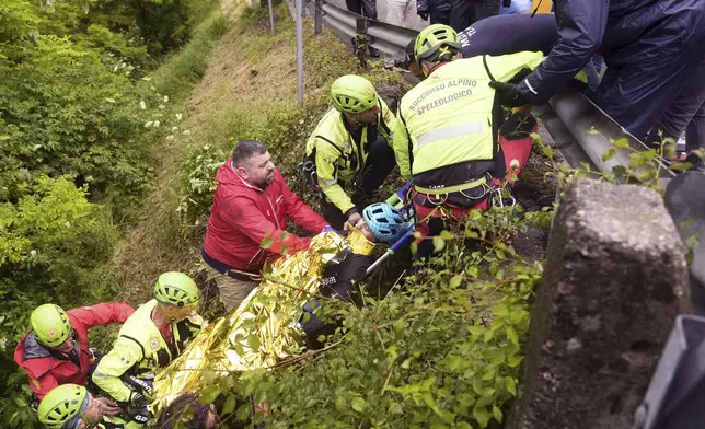 Italy's Alessio Martinelli of Vf Group Bardianicsf-Faizane is carried by rescuers after the fall during the stage 16 of the Giro d'Italia from Piazzola sul Brenta to San Valentino, Italy, Tuesday, May 27, 2025. (Fabio Ferrari/LaPresse via AP)