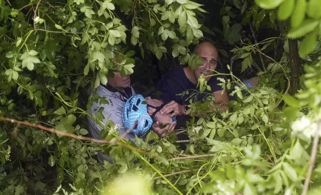 Italy's Alessio Martinelli of Vf Group Bardianicsf-Faizane is carried by rescuers after the fall during the stage 16 of the Giro d'Italia from Piazzola sul Brenta to San Valentino, Italy, Tuesday, May 27, 2025. (Fabio Ferrari/LaPresse via AP)