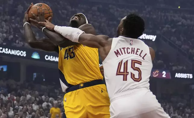 Indiana Pacers forward Pascal Siakam (43) is fouled by Cleveland Cavaliers guard Donovan Mitchell (45) in the first half during Game 2 in the Eastern Conference semifinals of the NBA basketball playoffs, Tuesday, May 6, 2025, in Cleveland. (AP Photo/Sue Ogrocki)
