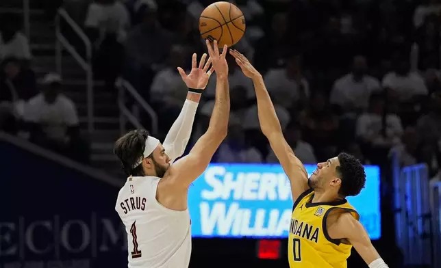 Cleveland Cavaliers guard Max Strus (1) shoots over Indiana Pacers guard Tyrese Haliburton (0) in the first half during Game 2 in the Eastern Conference semifinals of the NBA basketball playoffs, Tuesday, May 6, 2025, in Cleveland. (AP Photo/Sue Ogrocki)