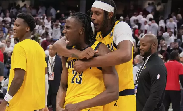 Indiana Pacers forward Aaron Nesmith (23) and center Myles Turner, right, celebrate after the Pacers defeated the Cleveland Cavaliers in Game 2 in the Eastern Conference semifinals of the NBA basketball playoffs Tuesday, May 6, 2025, in Cleveland. (AP Photo/Sue Ogrocki)