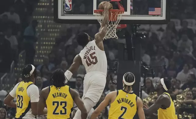 Cleveland Cavaliers guard Donovan Mitchell (45) dunks in front of Indiana Pacers center Myles Turner (33), forward Aaron Nesmith (23), guard Andrew Nembhard (2) and forward Pascal Siakam, right, in the first half during Game 2 in the Eastern Conference semifinals of the NBA basketball playoffs Tuesday, May 6, 2025, in Cleveland. (AP Photo/Sue Ogrocki)